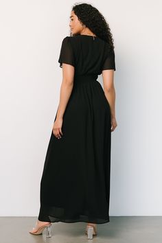 Deep black color High-quality chiffon material that flows beautifully V-neckline Short flutter sleeves Smocked waist for a comfortable fit Pull-over style Fully lined excluding sleeves Bump friendly 100% Polyester Nia is 5'9, cup size 32C, size 2 and wearing size S Flowy Chiffon Short Sleeve Dress For Evening, Evening Short Sleeve Chiffon Maxi Dress, Chic Evening Chiffon Dress With Short Sleeves, Fitted Black Dress With Elastic Waistband, Black Flowy Maxi Dress With Flutter Sleeves, Flowy Black Maxi Dress With Flutter Sleeves, Black Chiffon Dress For Date Night, Black Dress With Flowy Skirt And Short Sleeves, Elegant Black Dress With Short Sleeves And Flowy Skirt