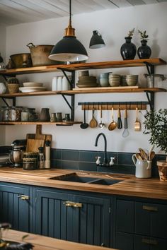 a kitchen with wooden counters and shelves filled with dishes