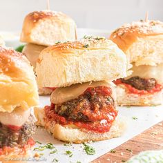 mini meatball sliders with marinara sauce and cheese on breaded buns