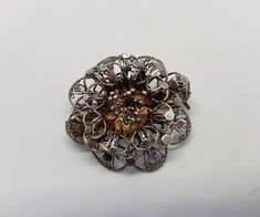 Very pretty vintage filigree flower brooch in 800 silver. The flower shape is beautifully designed in silver, though I cannot find any markings on the brooch, it does test positive for sterling, so it is at least 800 silver. This is a 40's-50's piece and is still in such great condition, it simply needs a good cleaning/polishing. This piece would make a terrific gift for a vintage jewelry lover. I'll ensure your order is fulfilled as requested. Visit my shop at: newagainclassics.ca -Shipping tim Collectible Silver Flower Jewelry, Vintage Silver Flower Pendant Jewelry, Vintage Silver Jewelry With Flower Pendant, Victorian Silver Brooch For Vintage Events, Vintage Sterling Silver Flower Brooches, Silver Victorian Brooch For Vintage Events, Silver Victorian Brooches For Vintage Events, Unique Silver Metal Brooch, Unique Silver Metal Brooches