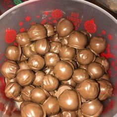 a bowl filled with chocolate covered candy on top of a table