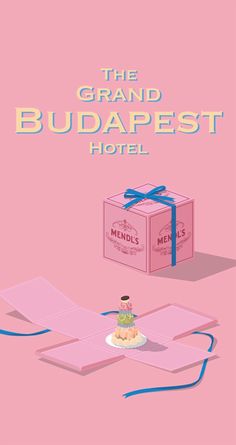 the grand budapest hotel poster with a cake in front of it and a gift box