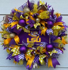 the wreath is decorated with purple, yellow and gold decorations for lsu's football team