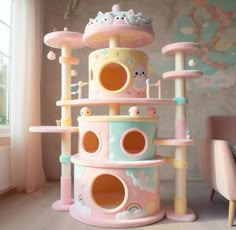 a pink and blue cat house with lots of cats on it's floors in front of a window