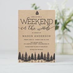 a card with the words weekend in the woods printed on it and surrounded by pine trees