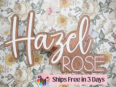 a wooden sign that says hazel rose on it with flowers and leaves in the background