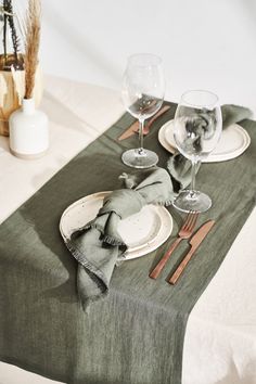 the table is set with silverware and napkins, along with two wine glasses