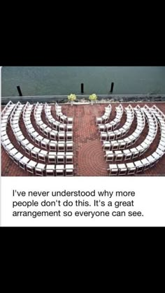 an empty auditorium with rows of white chairs