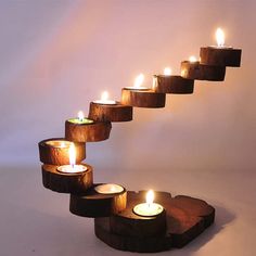 several lit candles are arranged in the shape of a spiral staircase