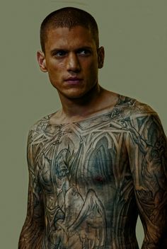 a man with many tattoos on his body