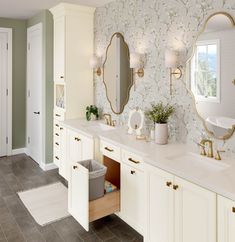 a bathroom with two sinks and mirrors on the wall