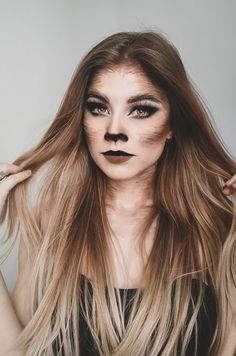 If you're howling at the moon this Halloween, go for a wild, untamed mane. Use hair gel and styling tools to create the perfect werewolf look. Cute Raccoon Makeup Halloween, Wolf Custome Halloween, She Wolf Makeup Halloween, Wolf Nose Makeup, Raccoon Face Makeup, She Wolf Makeup, Women Werewolf Costume, Cute Wolf Makeup, Werewolf Makeup Female Halloween