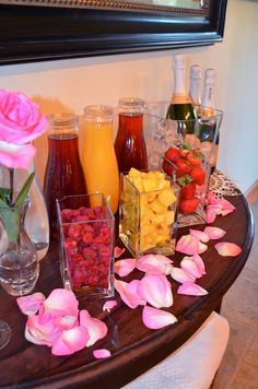 a table topped with vases filled with different types of fruit and drinks next to each other