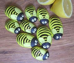 there are many yellow and black zebras on the table next to some lemons