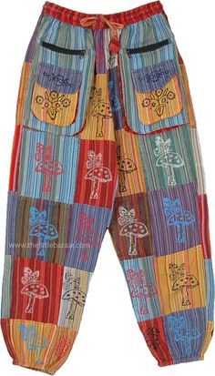 These bright multicolor mushroom print patchwork pants are very boho hippie style.  They have two souble-decker hippie pockets on either side with hippie motifs over them. #tlb #SplitSkirtsPants #Patchwork #Pocket #bohemianfashion #Handmade #unisexhippiepants #harempantswithpockets Patchwork Hippie Pants, Boho 2024, Bright Summer Outfits, Batik Pants, Bridesmaids Outfits, Hippie Shoes, Patchwork Pants, Cotton Overalls, Boho Hippie Style