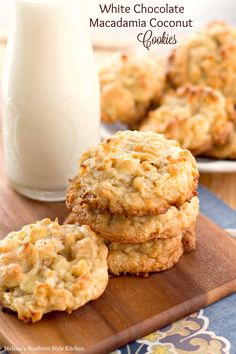 white chocolate macadamia coconut cookies on a cutting board next to a glass of milk