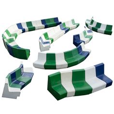 a set of green, white and blue striped benches with curved seats on each side