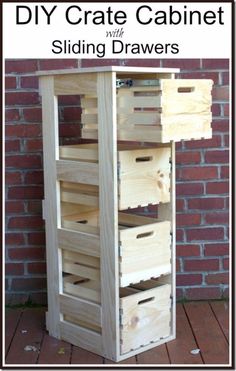 a wooden crate sitting on top of a wooden floor next to a brick wall