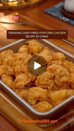 fried chicken in a pan on top of a wooden table with the words trending deep fried korean chicken recipe in china