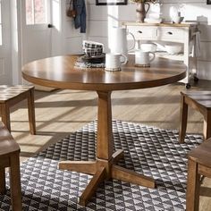 a wooden table and chairs in a room