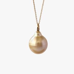 This lovely baroque Golden South Sea pearl is suspended from a 18K yellow gold bail. The pendant comes with a high quality gold-filled chain, made in Italy. This pendant is a perfect accessory to any outfit and would also make a fabulous gift for someone special. Each piece of our jewelry is unique and individually photographed. You will receive the exact item depicted in these images. Ready to ship. Gold Baroque Pearl Necklace With Round Pendant, Gold Briolette Pearl Necklace, Yellow Gold Baroque Pearl Pendant Necklace, Gold Baroque Pearl Necklace In Briolette Shape, Gold Briolette Baroque Pearl Necklace, Gold Pearl Necklace With Pear-shaped Pendant, Gold Pear-shaped Pearl Pendant Necklace, Yellow Gold Pear-shaped Necklace With Pearl Pendant, Pear-shaped Yellow Gold Necklace With Pearl Pendant