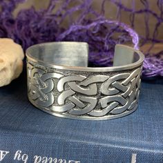 "Stunning! Our lead & nickle free Pewter Celtic Knot Bangle Bracelet features an ancient Celtic weave design that goes back thousands of years, embraced on both sides by a Celtic knot work pattern. Made of heavy, solid pewter that will never tarnish and designed to last a lifetime. A beautiful gift! Bracelet is in the cuff style with an open back and can be adjusted for almost any wrist size. A rich, traditional Celtic look at a very amazing price! About Pewter: Pewter is an ancient and trad Celtic Knot Work, Celtic Knot Bracelet, Celtic Weave, Knot Bangle, Work Pattern, Wiccan Jewelry, Gift Bracelet, Art Deco Pendant, Gift Girlfriend