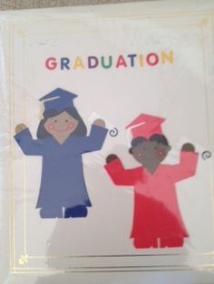 two children in graduation gowns are holding their hands up with the words graduation written on them