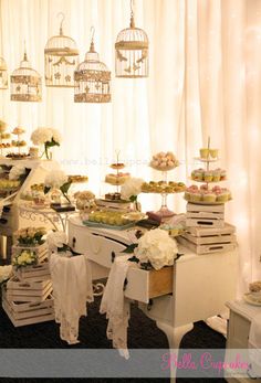 a table filled with lots of food next to a white piano and chandelier