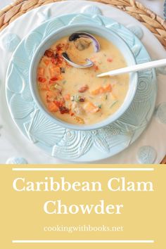 a bowl of crab and clam chowder on a blue plate with a spoon