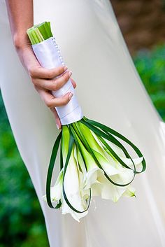 a woman holding a bouquet of flowers in her hand