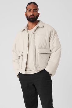 A fresh take on your favorite puffer, the Voyage Utility Cargo Jacket has a sharp collar, a zippered breast pocket and oversized front flap pockets that bring the cool factor. The silhouette is lightly filled (the perfect weight for brisk weather) with subtle quilting. The boxy, slightly oversized fit layers nicely over tees and hoodies—pair with the matching Voyage Utility Cargo Pants for a solid set. Utility Cargo Pants, Womens Onesie, Yoga Jacket, Cargo Jacket, Womens Capris, Yoga For Men, Alo Yoga, Mens Outerwear, Mens Sweatpants