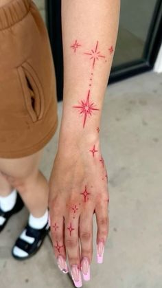 a woman's hand with red stars on it