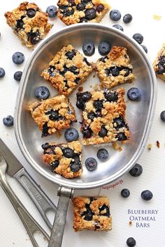 blueberry oatmeal bars in a metal pan next to utensils