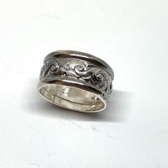 Here is a chunky, wide sterling silver which features a deeply etched floral middle section flanked by classic half-round sterling wires for a ring that it one part antique style and one part modern bohemian!  This ring is 7/16" wide (nearly 1/2"), and will be custom sized up to a 10. Makes a classic band ring, or a great thumb ring, too!  💎 Prefer a narrower but still chunky ring? Here is one with tanzanite: https://www.etsy.com/listing/1753538571/tanzanite-sterling-silver-ring-victorian?ref=l Engraved Wide Band Sterling Silver Jewelry, Sterling Silver Etched Wide Band Jewelry, Etched Sterling Silver Wide Band Jewelry, Sterling Silver Engraved Wide Band Ring, Sterling Silver Jewelry With Decorative Wide Band, Sterling Silver Wide Band With Decorative Design, Engraved Wide Band Heirloom Jewelry, Unique Engraved Wide Band Ring In Sterling Silver, Heirloom Wide Band Engraved Jewelry