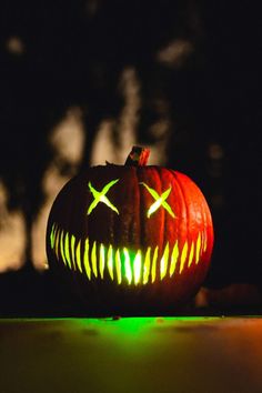 a lit up pumpkin sitting on top of a table