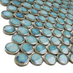 blue glass tile with silver circles on the bottom and sides, all in different sizes