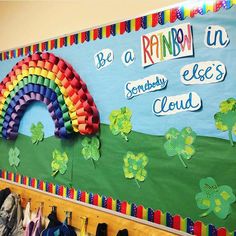 a bulletin board decorated with rainbows and shamrock leaves