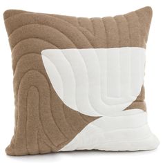 a brown and white pillow sitting on top of a table