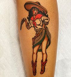 a woman wearing a sombrero and holding a knife on her leg with tattoos