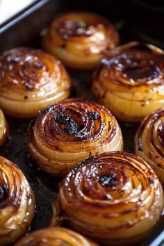 some very tasty looking pastries in a baking pan on the stove burner