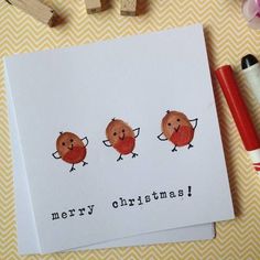 three red birds on white card with merry christmas written in black ink next to markers and pencils