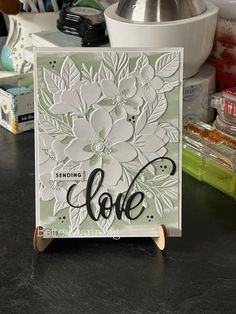 a close up of a card on a table with scissors and other crafting supplies