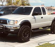 a white pickup truck parked in a parking lot