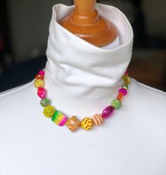 "This Fun set has a mix of beads in a mix of colors shapes and sizes. Has a nod to the 80's with the bright colors. There is everything from yellow wire, glass and acrylic and clay bead, light green clay and acrylic beads, fuchsia pink acrylic and glass beads and Orange glass and acrylic beads. Beaded are on a heavy beading wire then hand sewn on to black satin ribbon.  Covered with silver finished cones. The ribbon is long and can be hand tied so the necklace can be worn at different lengths. A Hand Stamped Cuff Bracelet, Multi Coloured Necklaces, Green Clay, Ribbon Necklace, Pink Acrylic, Clay Bead, Pink Acrylics, Necklace And Earrings Set