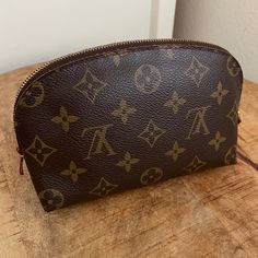 Compact, Travel-Ready Louis Vuitton Cosmetic Pouch In Iconic Monogram Coated Canvas, Accented With Natural Vachetta Leather Details And Gold-Tone Brass Hardware. Authentic, Htf Fan Favorite Currently Out Of Stock Online Zip-Around Curved Closure One Interior Slip Pocket Made In Spain M47515 Measures Approximately: 6.75" X 4.5" X 2.5" Exterior Is In Excellent Condition Smooth Zipper, Works Perfectly Interior Has Water Stain Smudge On Tag, No Rips Or Scents Some Scratches & Discoloration On Brass Louis Vuitton Cosmetic Pouch, Louis Vuitton Gm, Pm Monogram, Water Stains, Cosmetic Pouch, Brass Hardware, Monogram Canvas, Cosmetic Bag, Scents