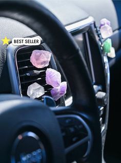 the dashboard of a car with crystals on it