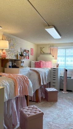 a bedroom with two twin beds and pink curtains