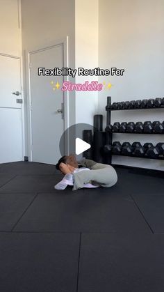 a person laying on the ground in front of a gym