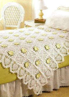 a white crocheted bedspread with yellow flowers on it