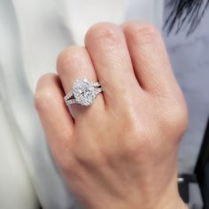 a woman's hand with a diamond ring on it